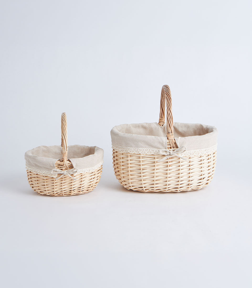 Handwoven wicker baskets with beige linen and lace trim, arched handles, nested sizes
