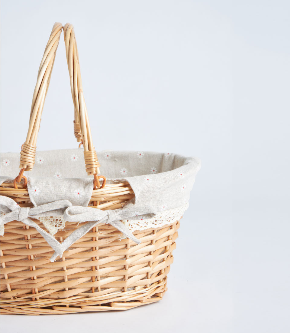 Light wicker oval basket with fabric daisy liner and double handles