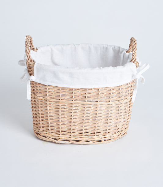 Handwoven oval wicker basket with white fabric liner and braided side handles