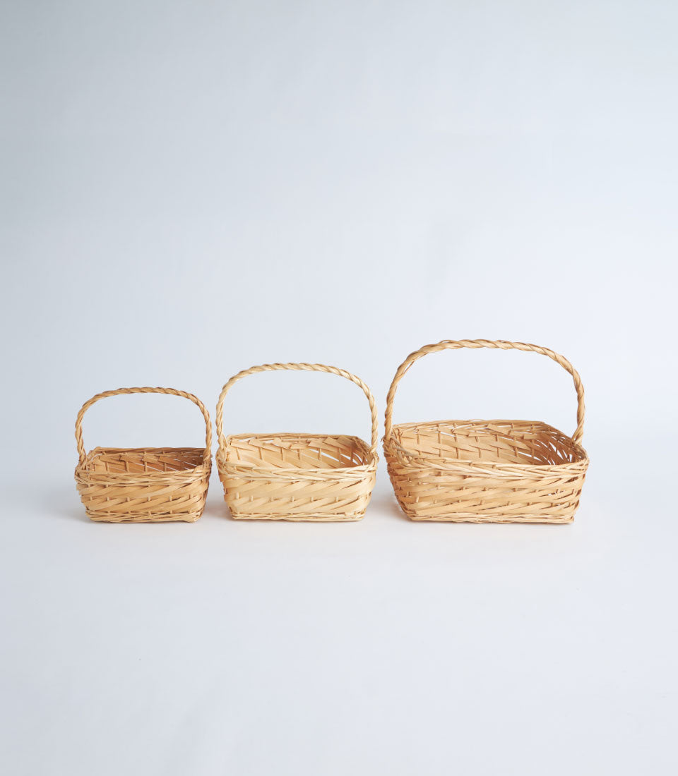 Natural woven bamboo baskets with handles in graduated sizes, light tan wicker gift containers