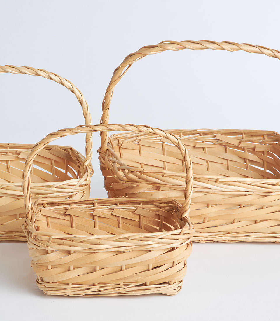 Natural woven bamboo rectangular baskets with handles in three sizes for curated gift hampers