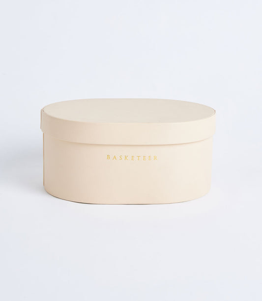 Beige leather storage box with gold Basketeer branding, lid included