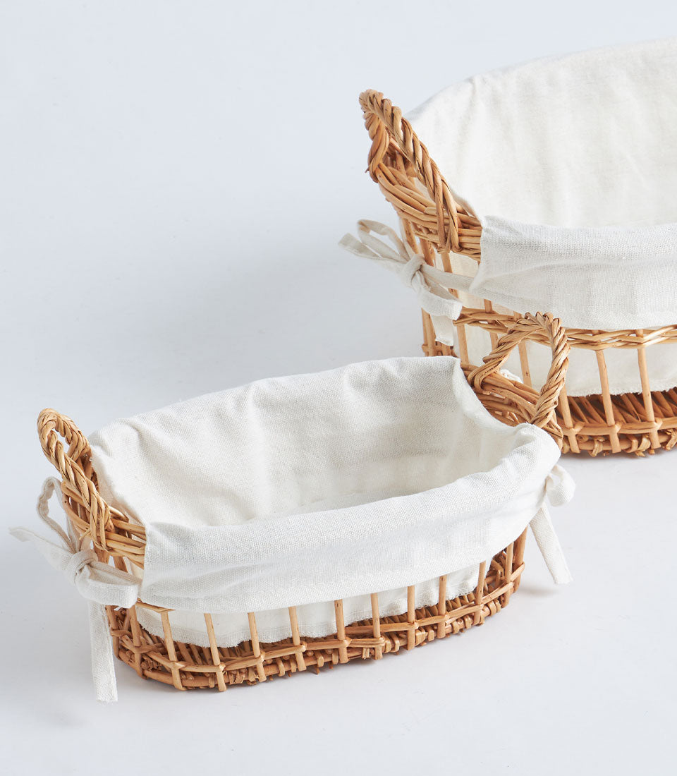 Natural woven wicker baskets with white fabric liners and rope handles