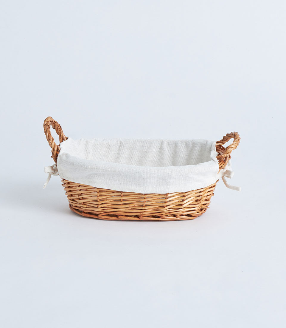 Natural woven wicker basket with linen lining and white fabric bows