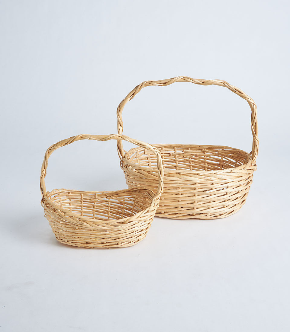 Handcrafted natural wicker oval baskets with twisted handles in two sizes