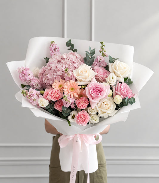 A romantic bouquet from Flowers by Basketeer featuring blush pink O'Hara and ivory