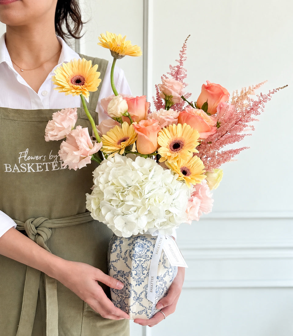 Elegant vase arrangement from Flowers by Basketeer featuring white hydrangeas, peach