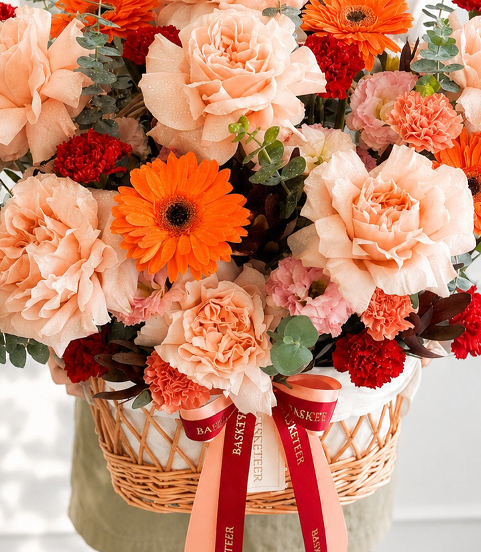 A luxurious Flowers by Basketeer arrangement featuring vibrant orange gerberas