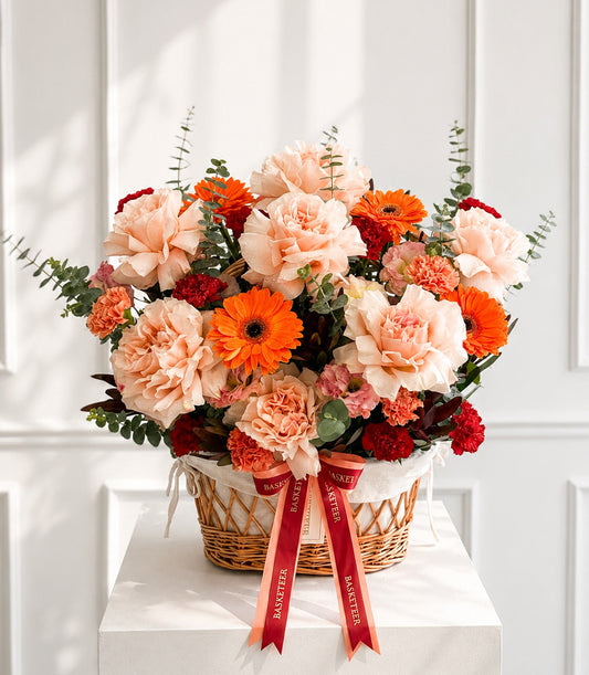 Elegant floral basket arrangement from Flowers by Basketeer featuring lush peach carnations,