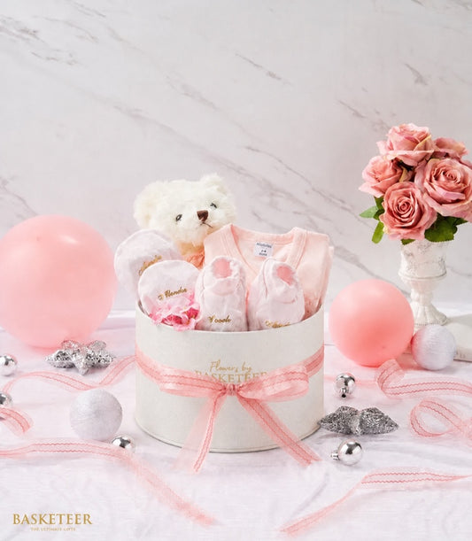 Basketeer's luxurious pink baby gift box, tied with delicate