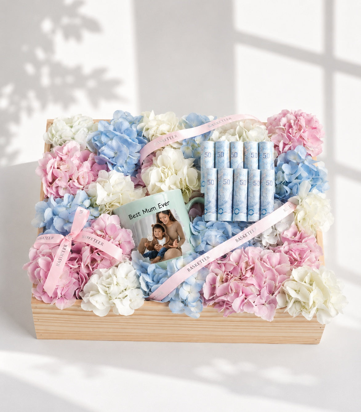 Elegant gift box by Flowers by Basketeer featuring a personalized mug and rolled money