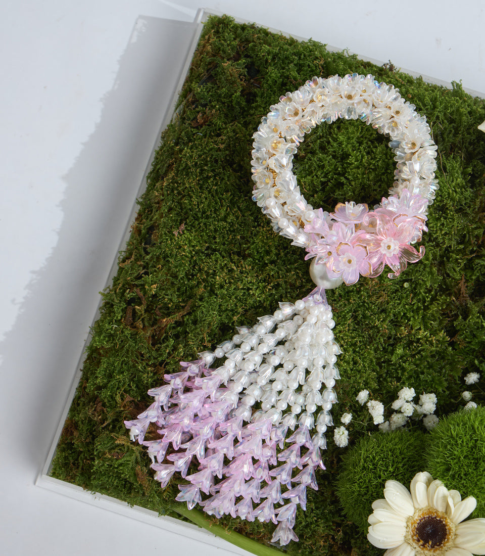 Floral moss wall art featuring a decorative number 8 made with white and pink flowers on preserved green moss background with white gerberas.