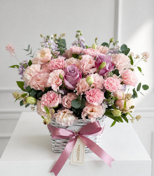A luxurious floral basket arrangement by Flowers by Basketeer, featuring premium pastel pink carn