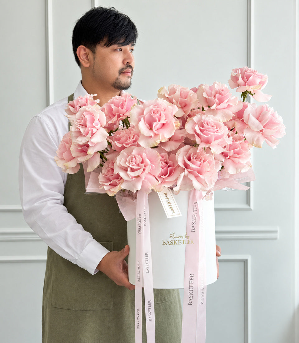Model-held angled view of pink rose and hydrangea flower box