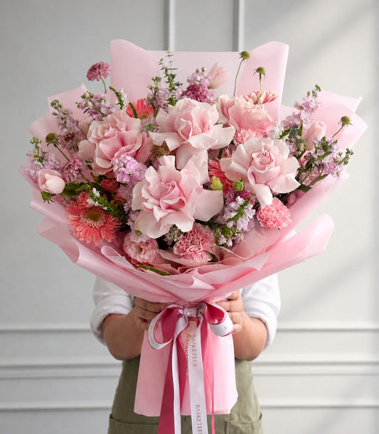 Basketeer luxury gift bouquet with lush pink Mondial roses, tulips, and