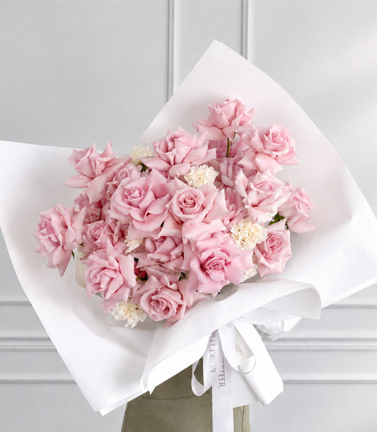 Basketeer's luxurious pink rose bouquet with delicate white accents, elegantly