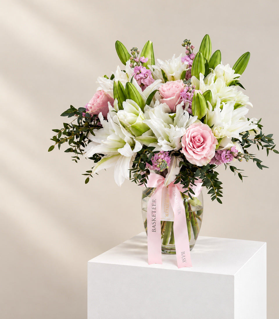 Angled full view of Roselily Blush flower vase with pink roses, white lilies, and greenery
