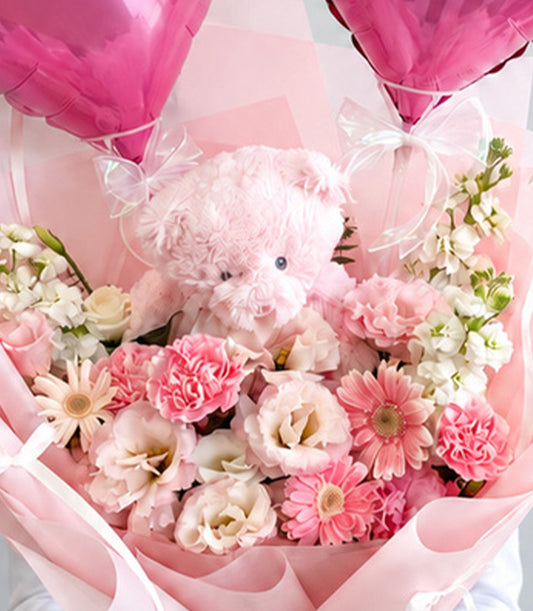 Basketeer's luxurious flower bouquet featuring a plush pink teddy bear, vibrant