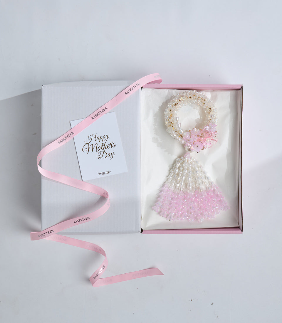 Elegant Mother's Day gift set featuring a decorative beaded wreath with pink flowers and a matching tassel ornament in white box with pink ribbon.
