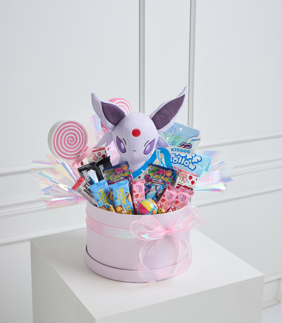 Pink gift box filled with candies, Pokemon plushie with white face and purple ears, lollipop, and iridescent decorative elements.