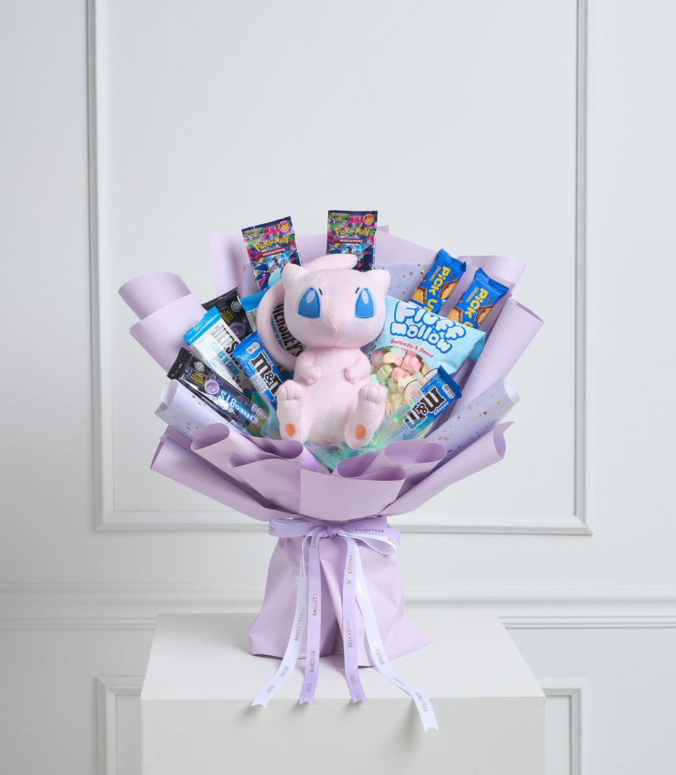 Pink Pokémon plush bouquet with candy and snacks wrapped in purple tissue paper, tied with lavender ribbons.