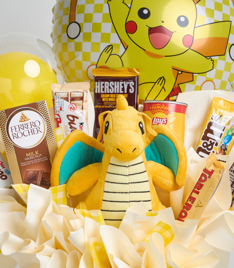 # Alt Text

Pokemon Pikachu plush toy surrounded by snacks and chocolates including Hershey's, Ferrero Rocher, and Lay's chips against yellow checkered backdrop.