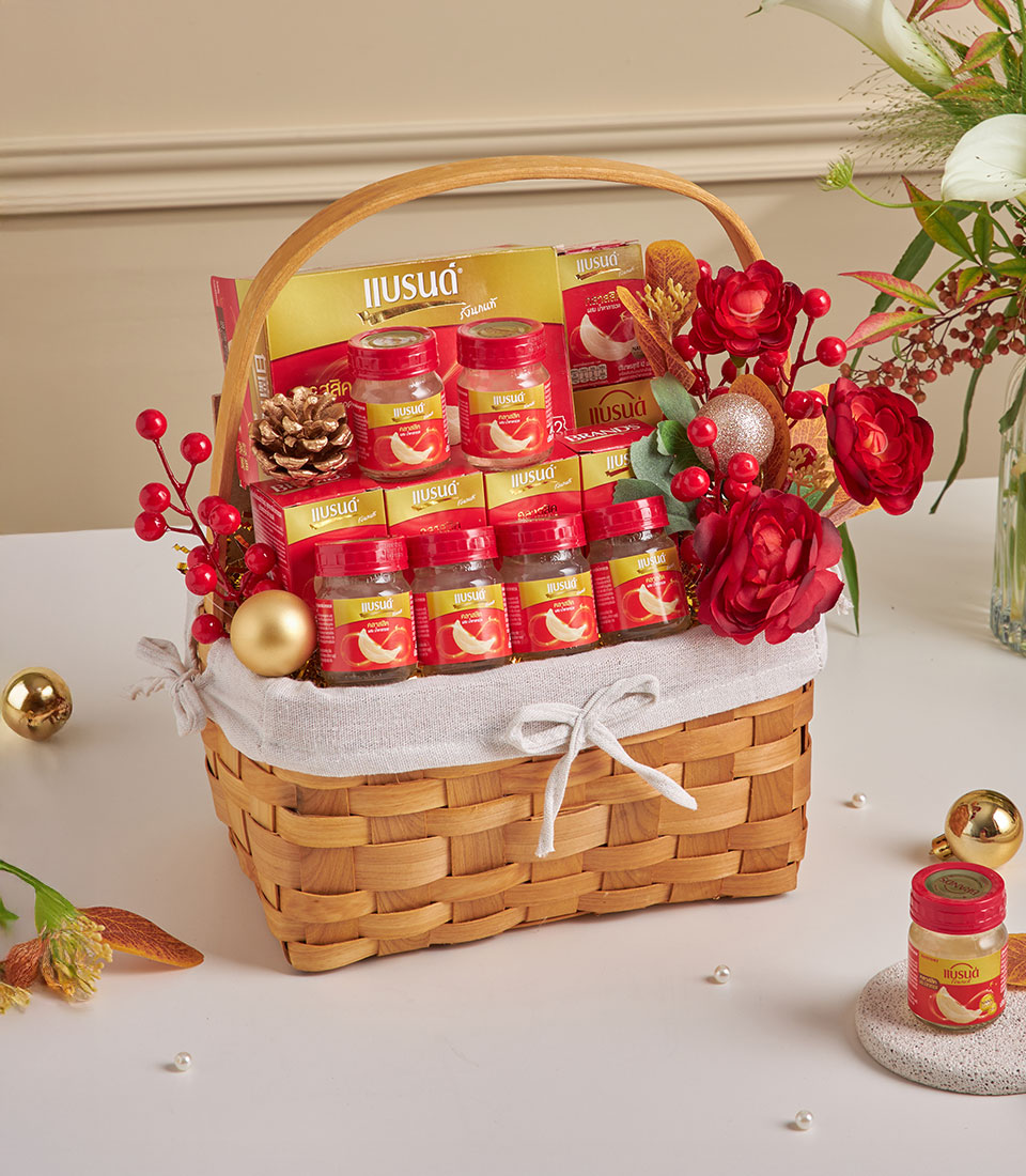 Luxury bird's nest health hamper with glass jars, gold boxes, and festive red accents for New Year gifting