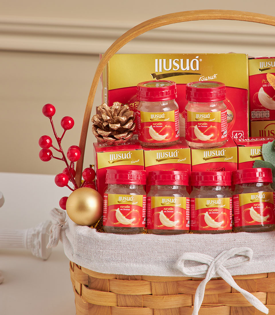 Premium bird's nest health drink gift basket with glass bottles and boxes, woven in natural tan with white bow, festive red