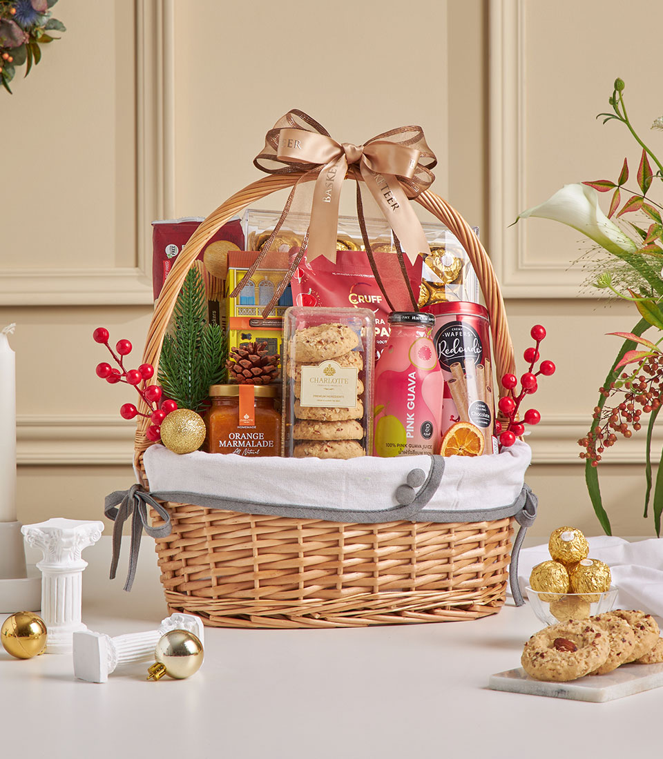 Festive spiced guava and chocolate snack hamper with wicker basket, gourmet treats, and holiday decor