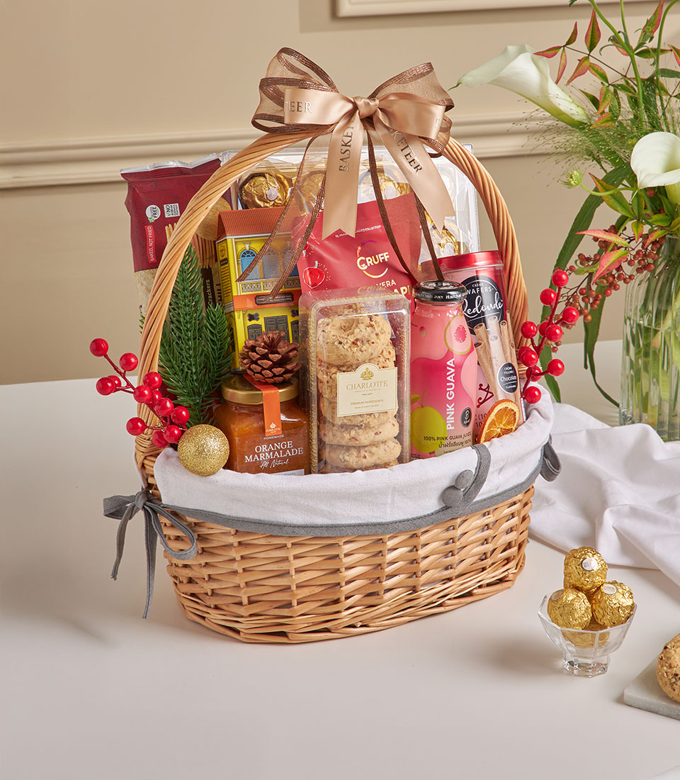 Wicker gift basket with spiced guava juice, chocolate, Charlotte cookies, and marmalade for New Year
