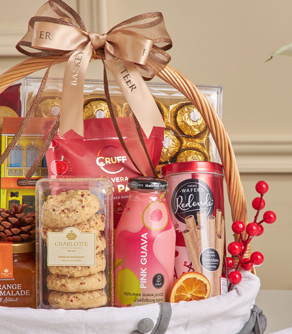 Woven wicker gift basket filled with spiced guava juice, chocolate wafers, gourmet cookies, and artisan chocolates for New