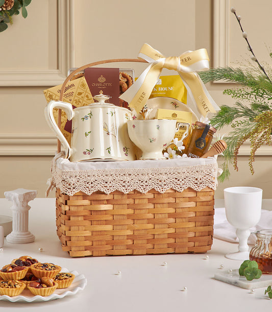 Wicker tea time hamper with ceramic teapot, teacup, chocolates, and honey for New Year gifting