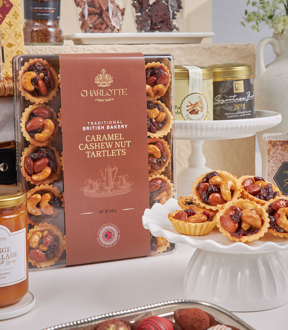 Premium New Year gift box with caramel cashew tartlets, British bakery treats, marmalade, specialty coffee and tea selection