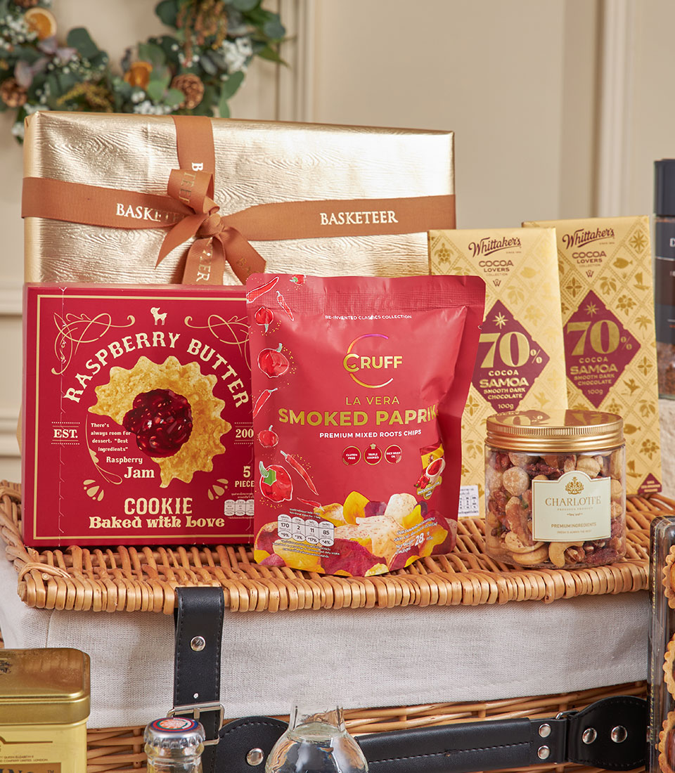 Luxury New Year gift basket with gourmet chocolates, cookies, chips, nuts, and festive wrapping in wicker hamper