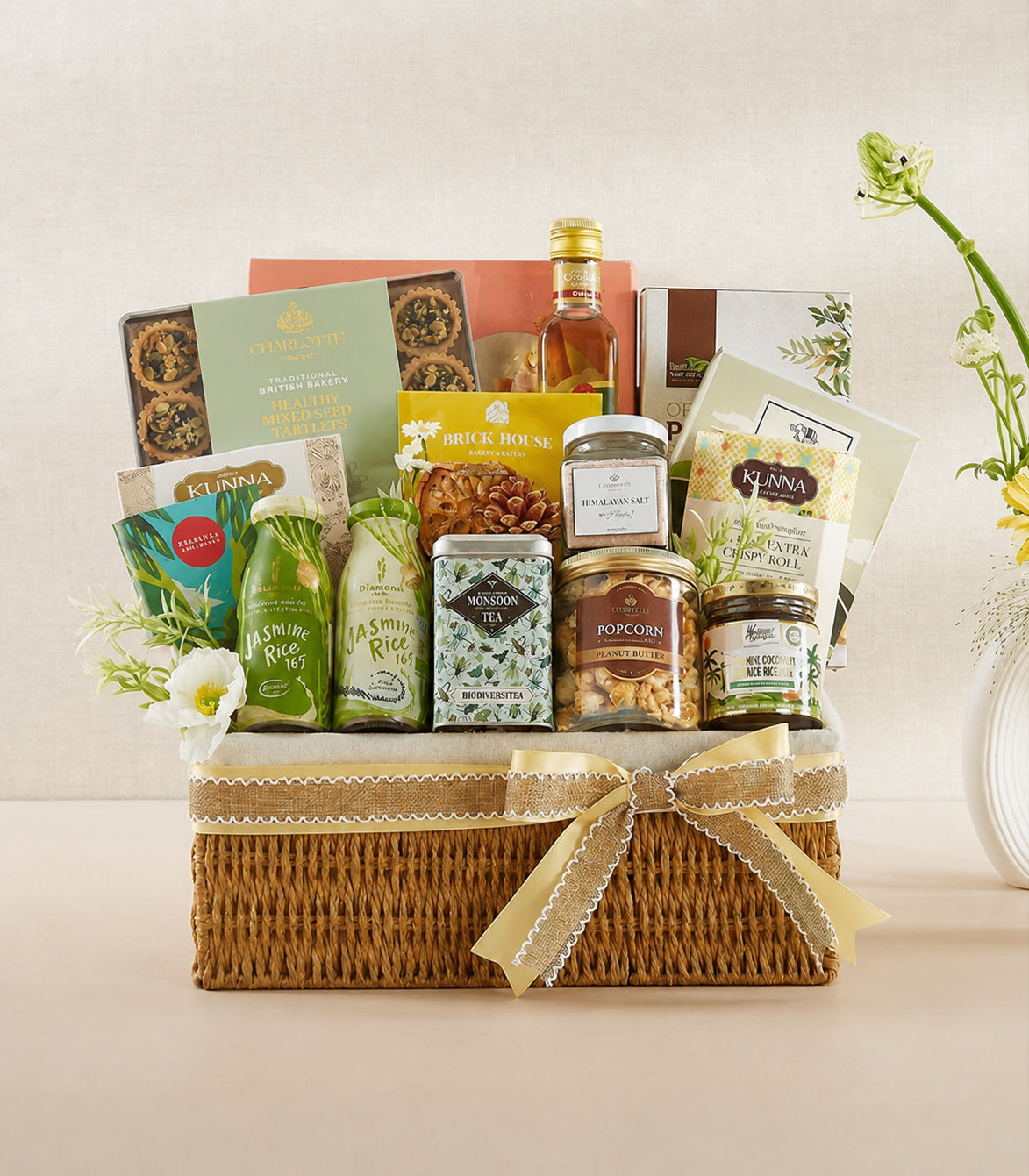Basketeer luxury gourmet hamper with a woven wicker basket, adorned with a