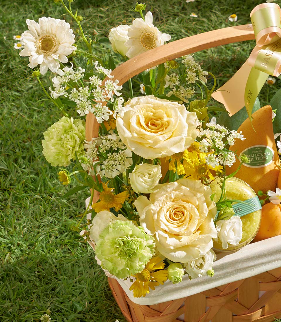 Premium mango and sticky rice gift basket with cream roses, carnations, and daisies by Flowers by Basketeer