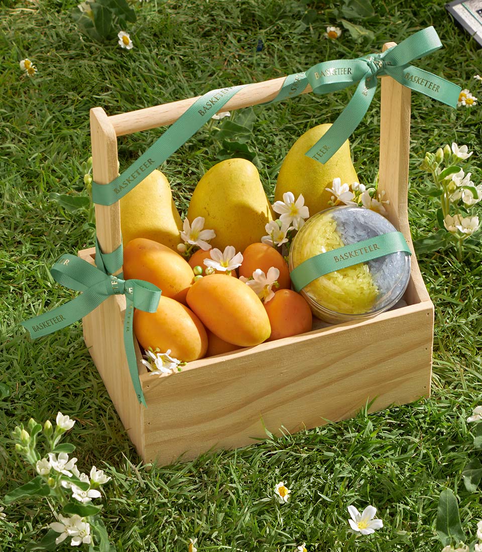 Premium wooden gift box with fresh Thai mangoes, tropical fruits, and artisan sticky rice delicacy