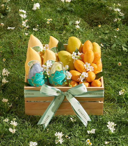 Premium mango and sticky rice gift basket in wooden crate with tropical flowers