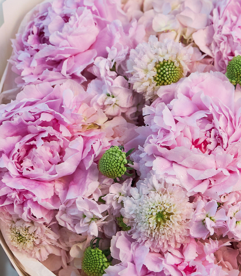 Lush bouquet by Flowers by Basketeer featuring romantic pink peonies, delicate
