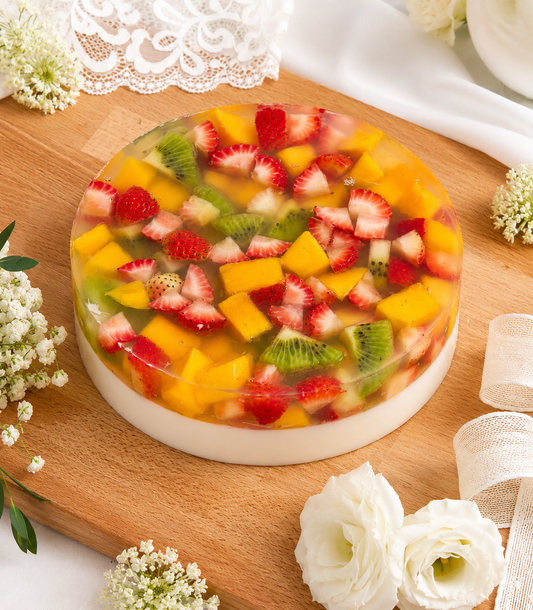 Charlotte Bakery's vibrant round Sunshine Fruit Coconut Jelly Cake, a refreshing artisan