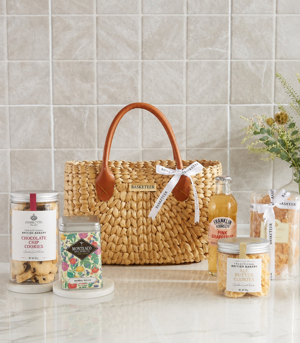 Basketeer luxury gift bag, a woven straw hamper with leather handles