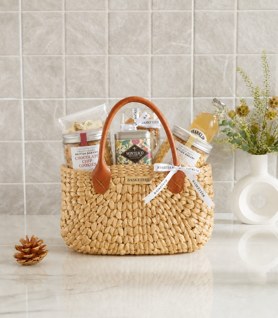 Basketeer's premium hamper featuring a natural woven straw tote with leather handles