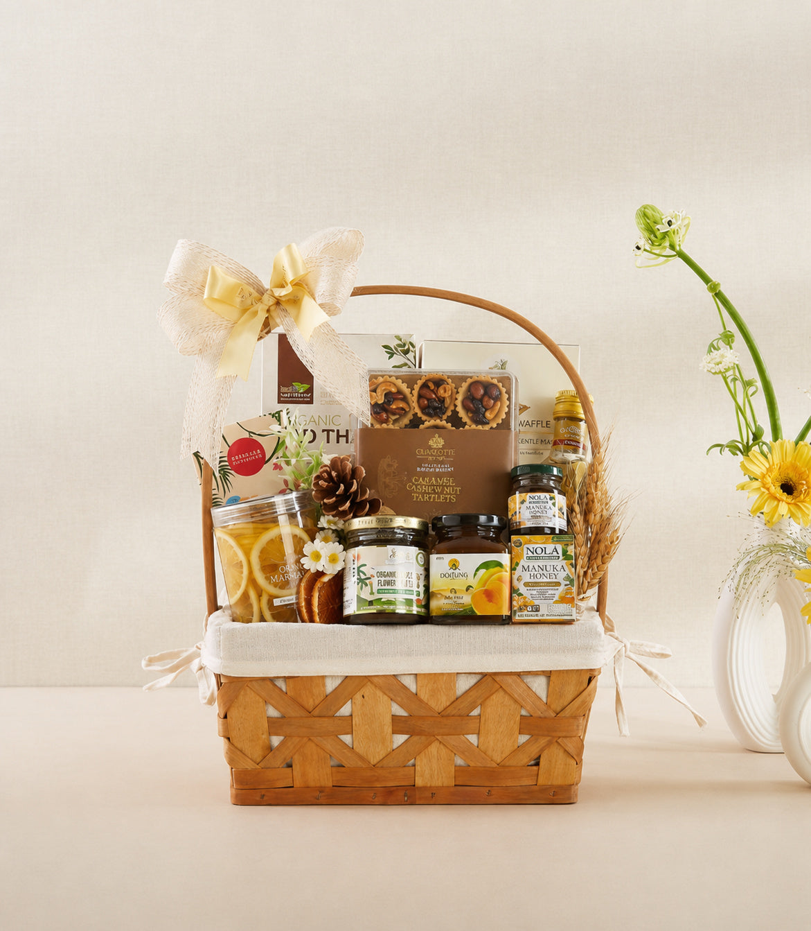 Basketeer premium gourmet hamper with elegant cream bow, filled with