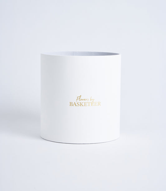Mist grey cylindrical flower gift box with gold Basketeer logo, luxury premium packaging for fresh flowers