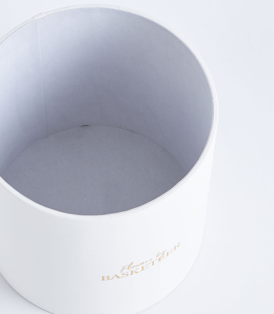 Premium Basketeer round gift box in mist grey, featuring elegant gold