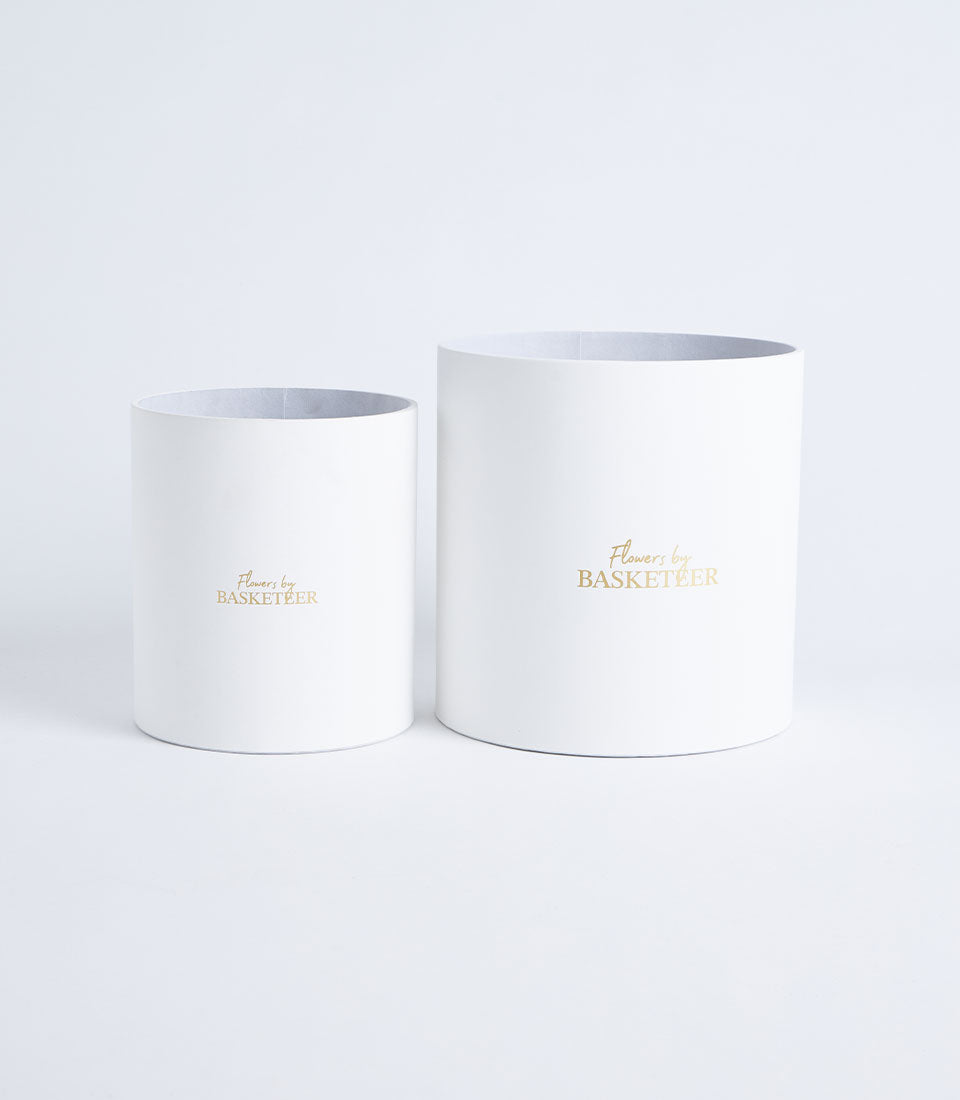 Two elegant round mist grey flower gift boxes, one large and one small