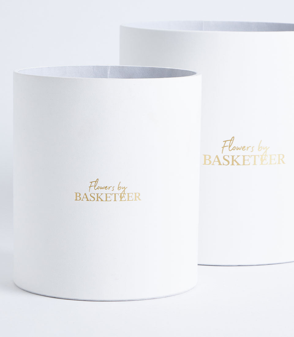 Elegant Basketeer flower gift boxes in mist grey, featuring luxurious gold foil branding.