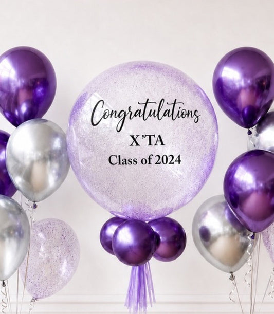 Purple and silver metallic balloons with a large glittery purple balloon displaying "Congratulations X'TA Class of 2024" text on white background.