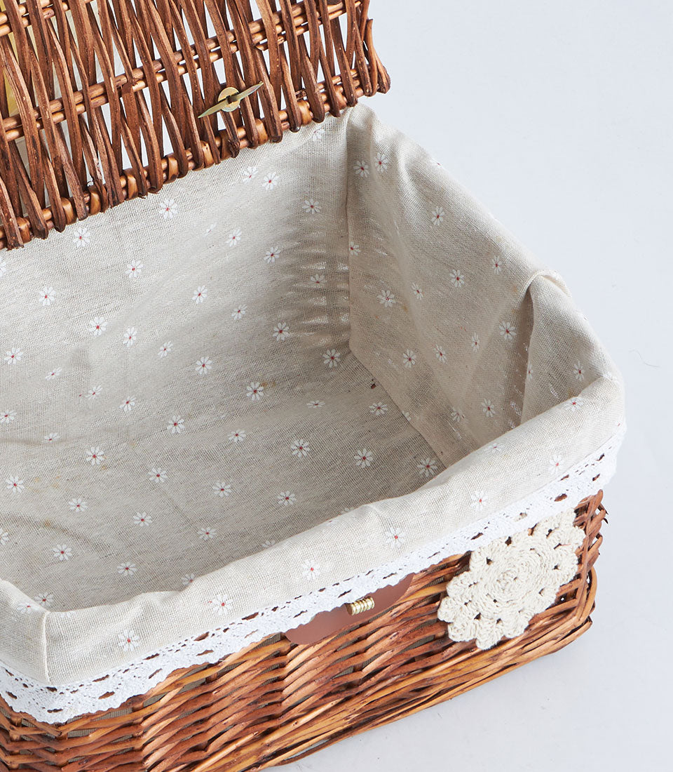 Dark brown wicker storage basket with hinged lid, cream floral crochet trim, and floral fabric interior with lace detailing
