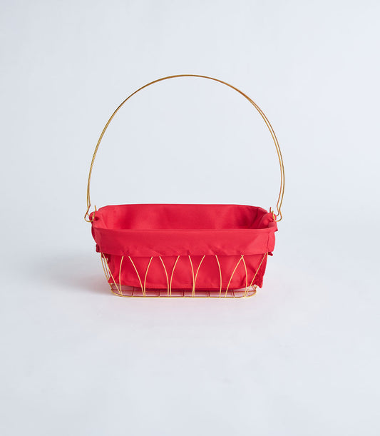 Gold metal wire basket with red fabric lining and arched handle for luxury gift presentation